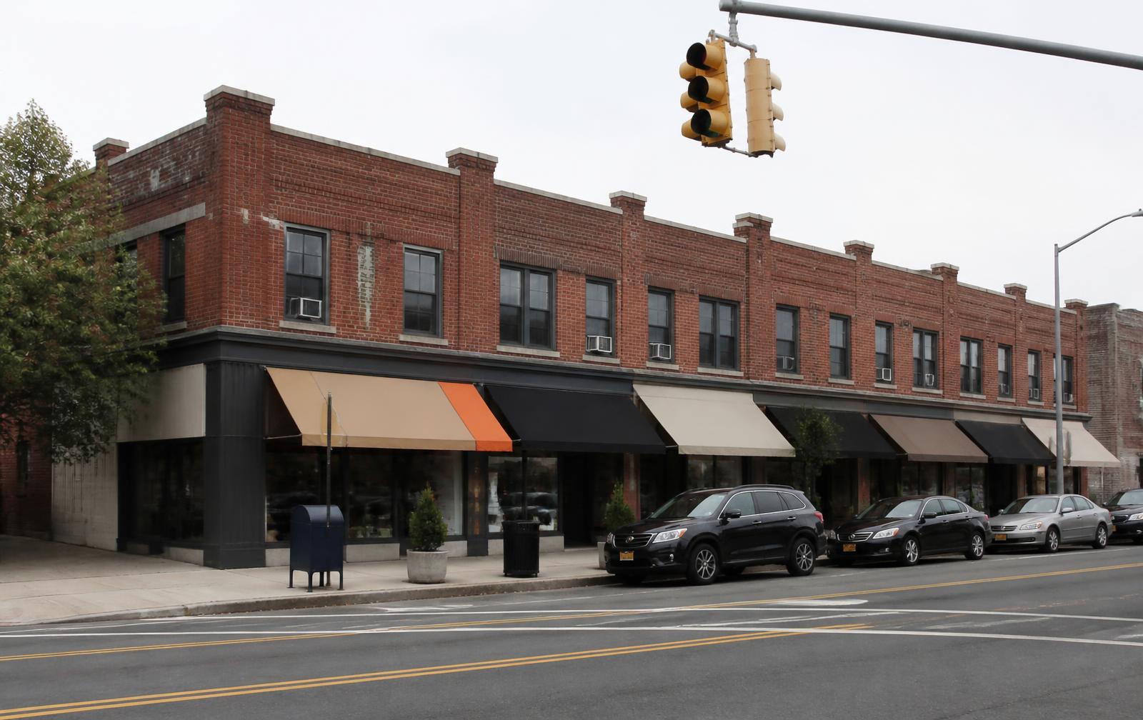 Central Avenue storefronts in Plaza Midwood at dusk