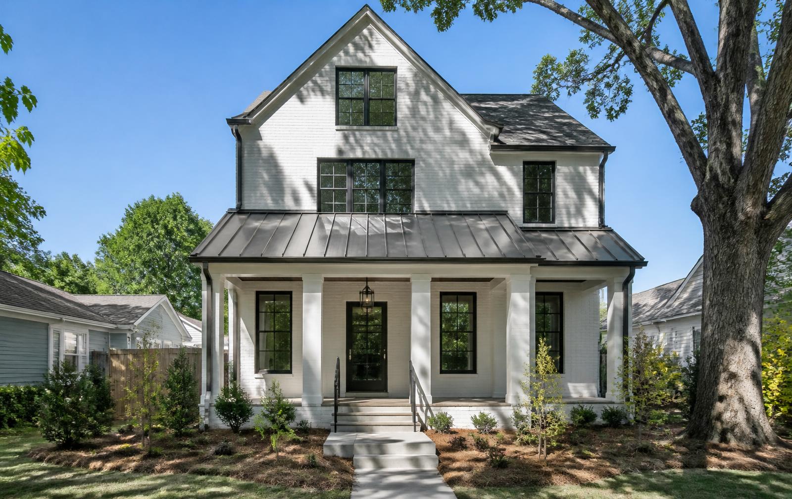 Custom-built infill home with metal porch roof and painted brick