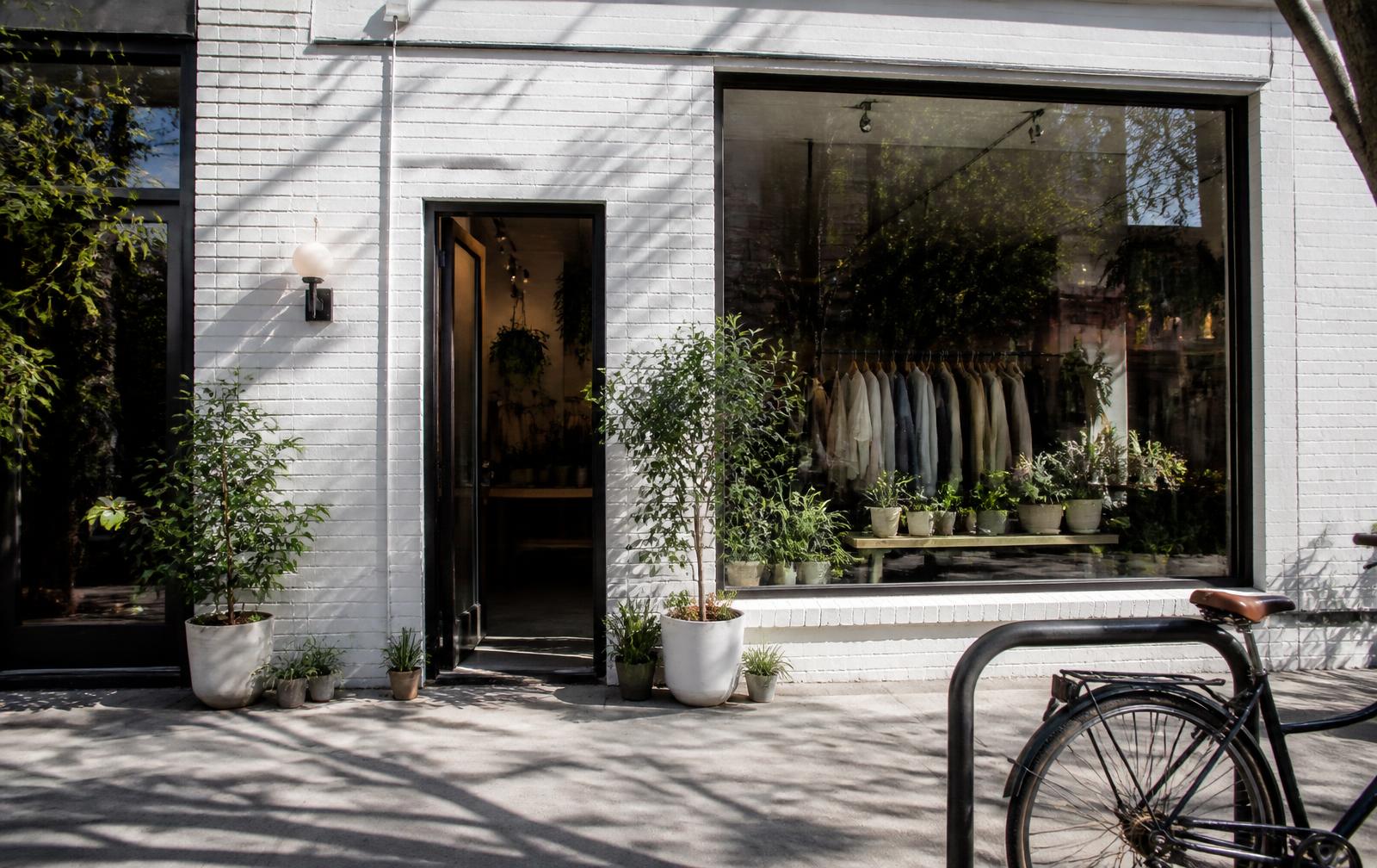 Independent boutique storefront with plants and bicycle rack